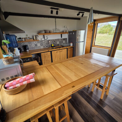 Fully equipped kitchen and dining table with Patagonian views at Casa Lenga, Puerto Natales