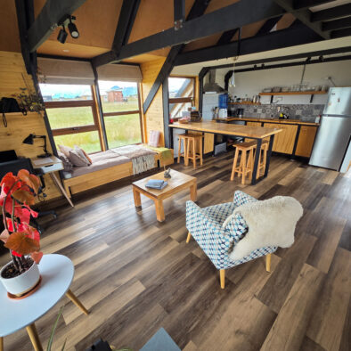Bright living room with large windows and Patagonian views at Casa Lenga