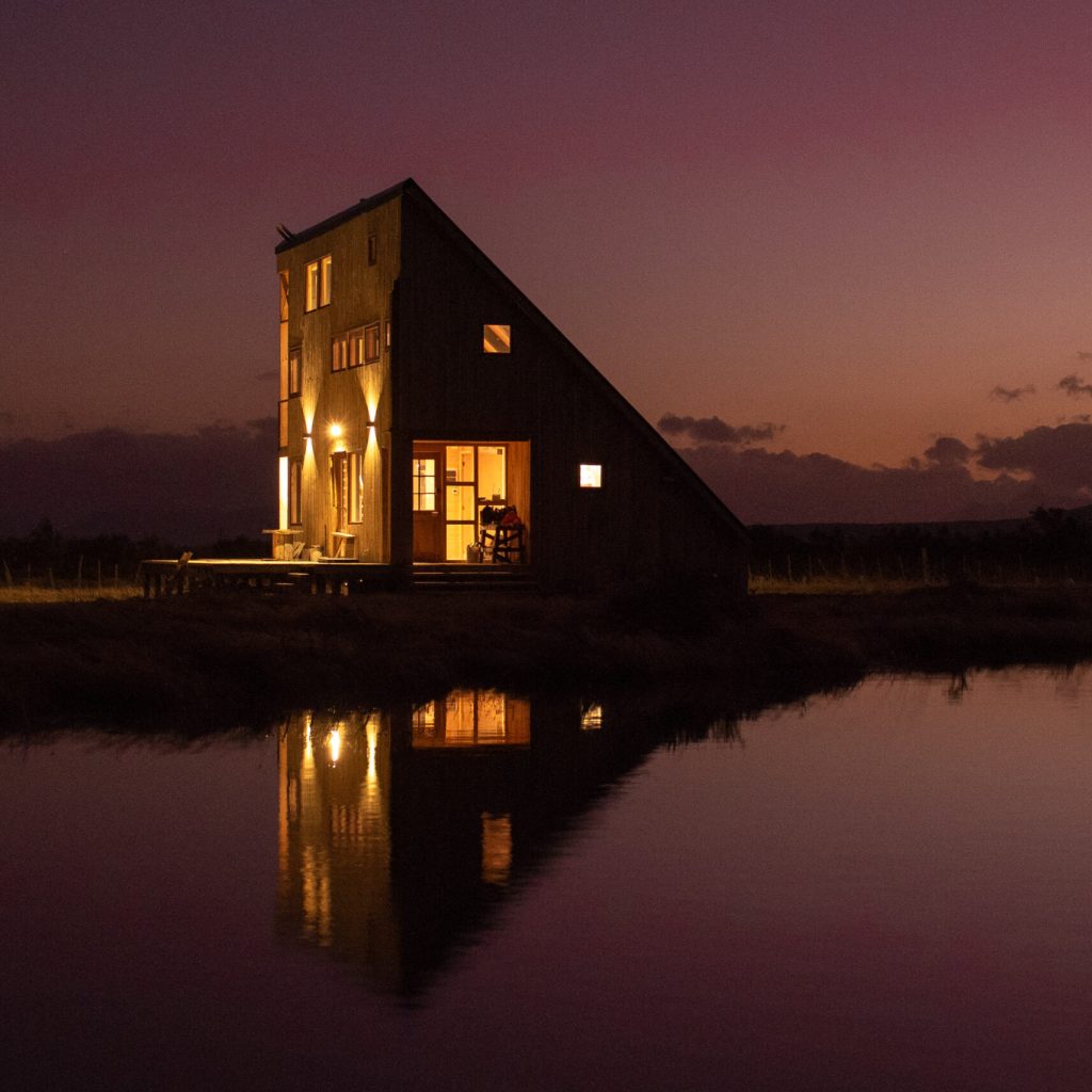 Casa Lenga exterior illuminated at night, Patagonia Chile